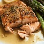 Flaky lemon garlic butter salmon fillet served with roasted asparagus and fresh